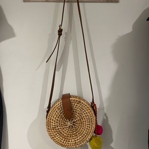 Cute cross body bag with pom poms.